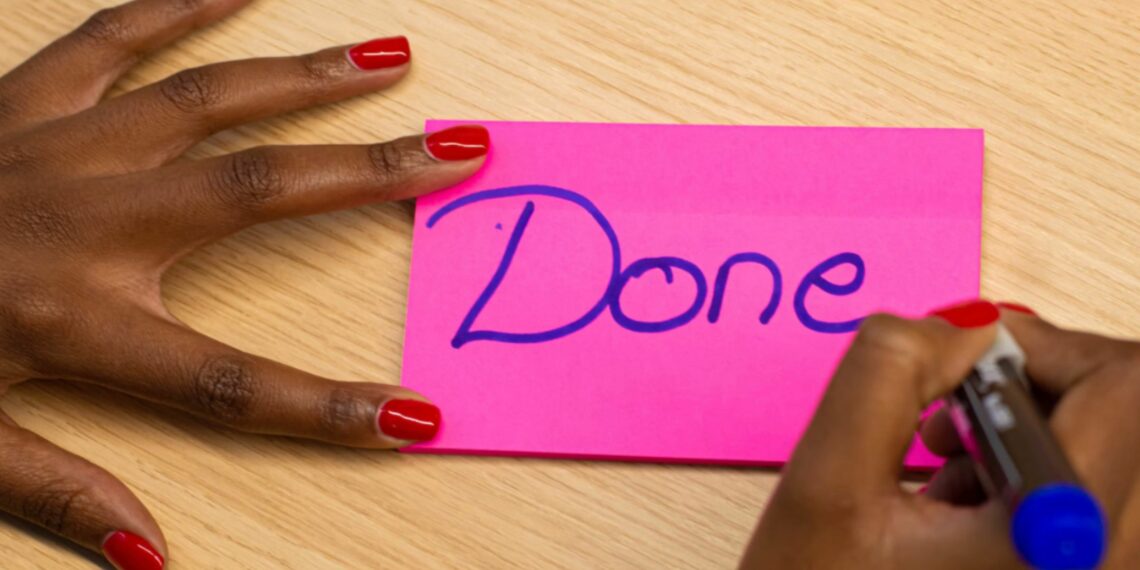 pink post-it with done righting on