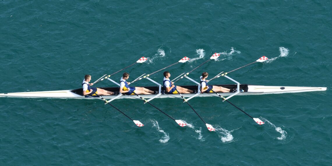 people rowing together