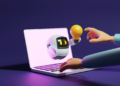 A hand writing on a computer and a small robot on a screen
